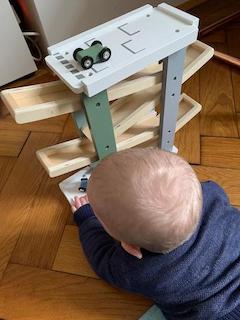 Enkel spielt mit Holz-Murmelbahn